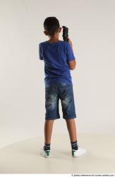 TIMBO STANDING POSE WITH GUN